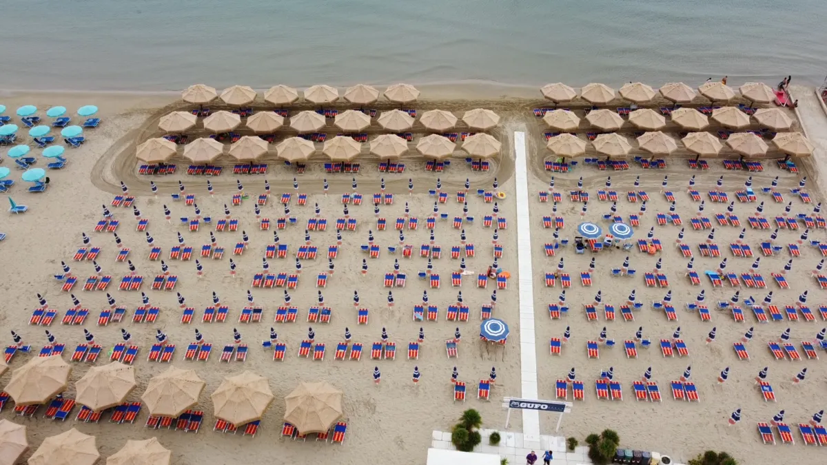 Vista aerea dello stabilimento Il Gufo con ombrelloni e lettini sulla spiaggia